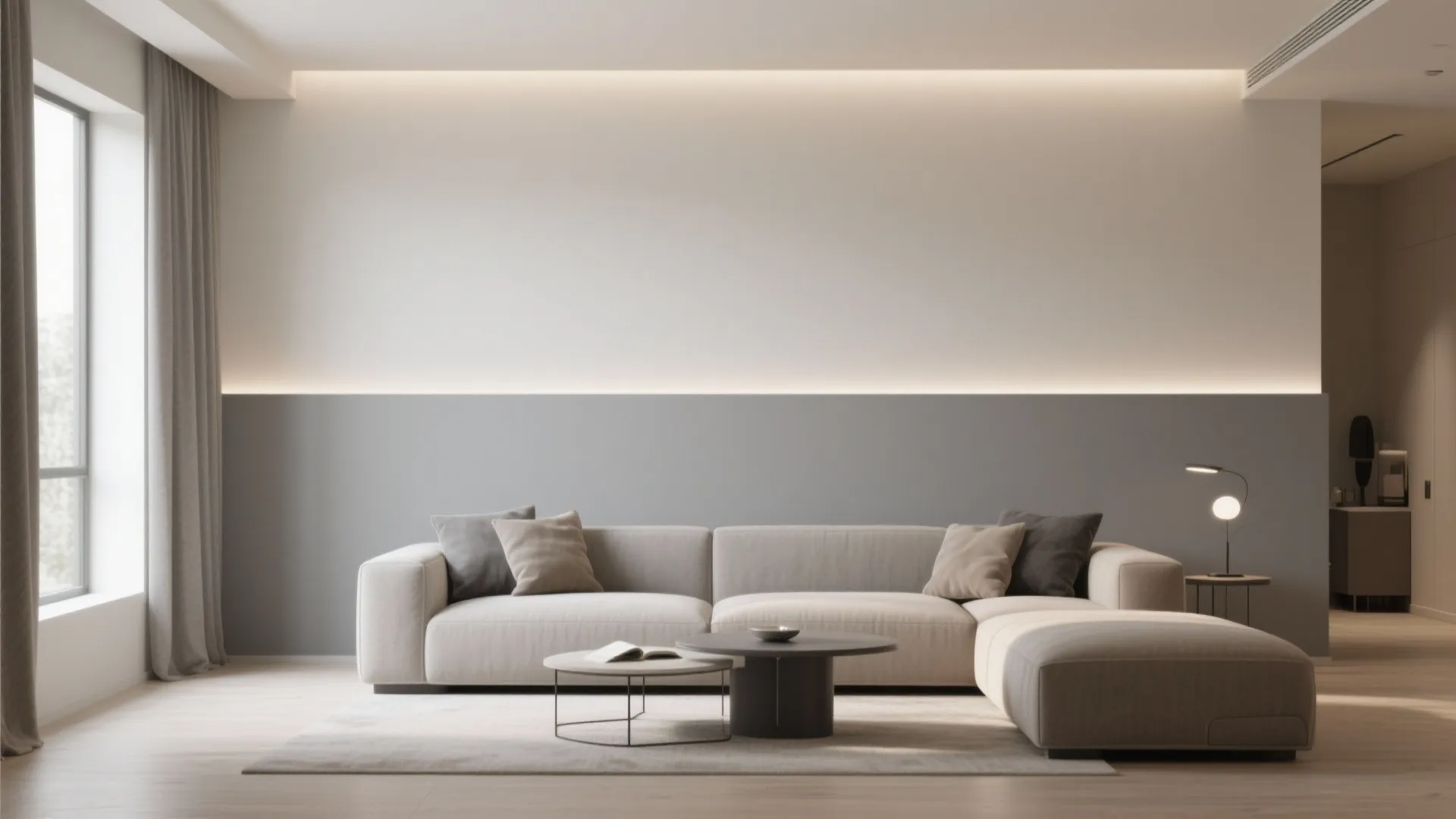 Modern living room featuring two tone grey wall putty behind a cream sofa and cushions