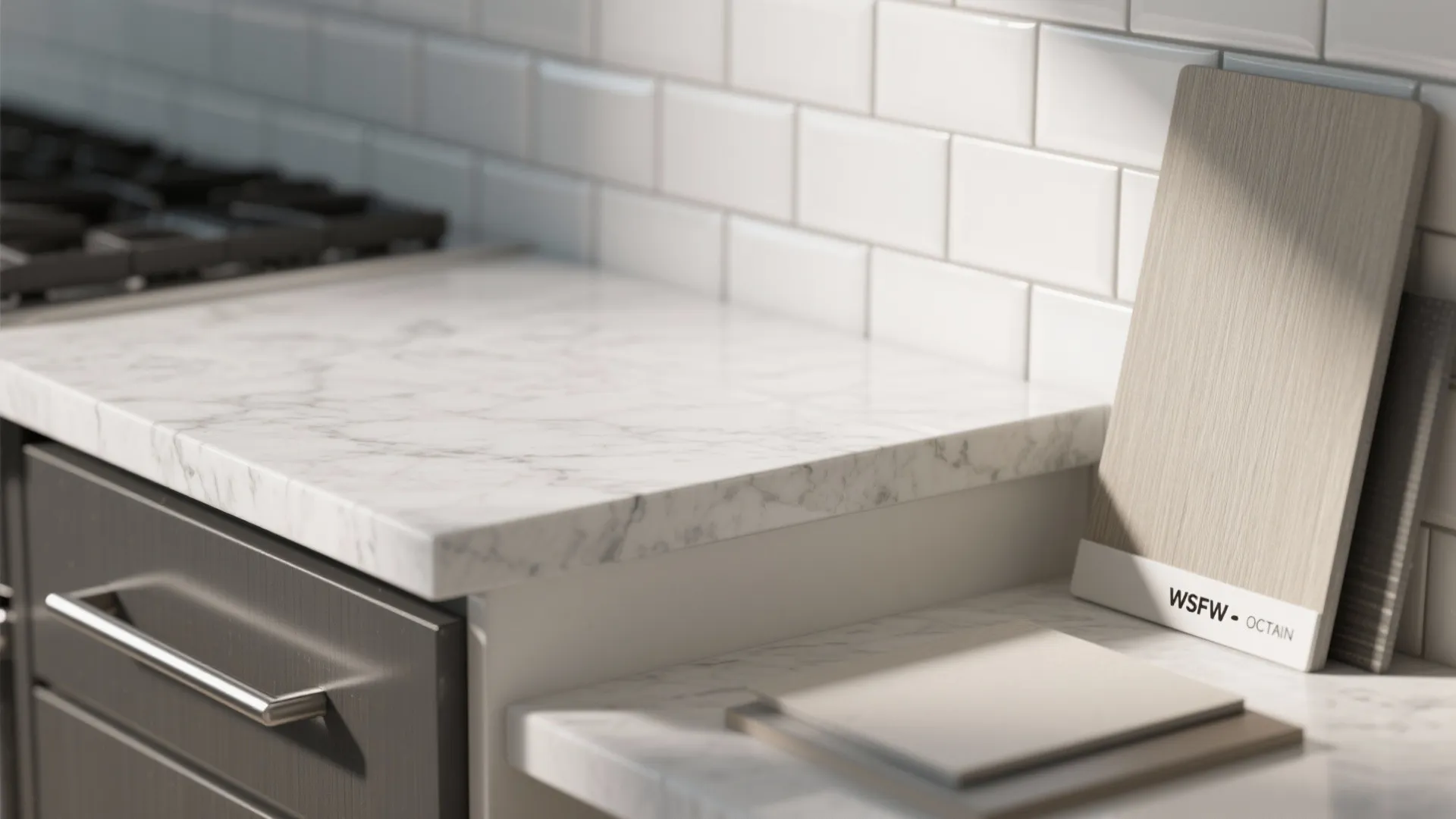 White marble countertop with white subway tile wall and wood material samples in bright kitchen