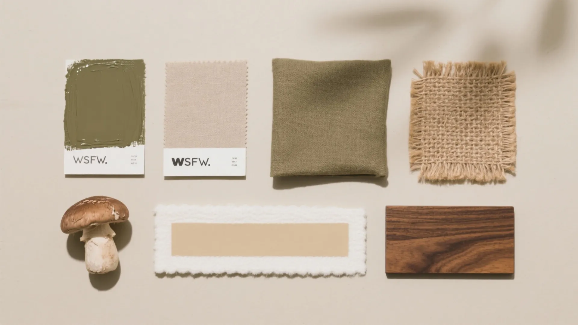 Interior design mood board with green paint fabric samples wooden block and a small mushroom