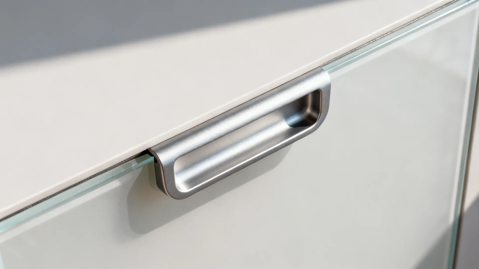 Close-up of an aluminum J-profile edge handle with precise finger recess.