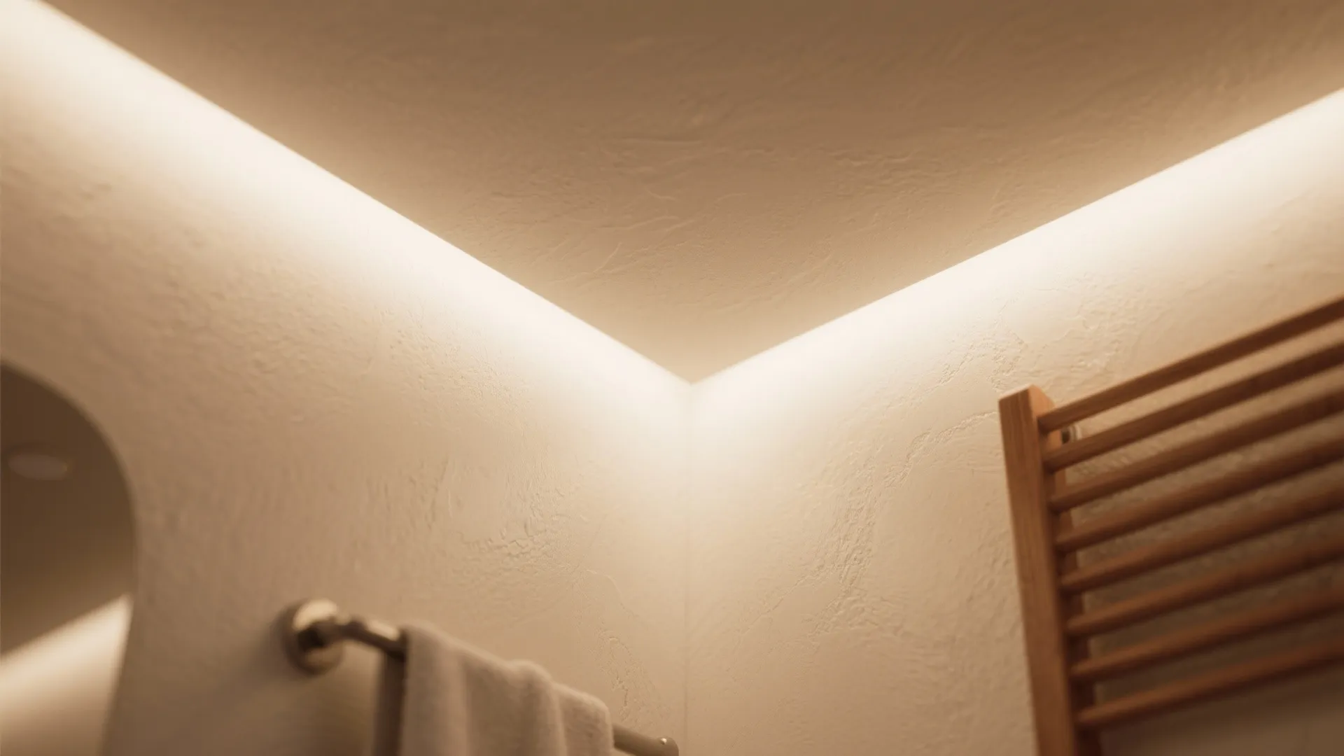 Close up view of textured ceiling with warm light fixture and white towel on wall