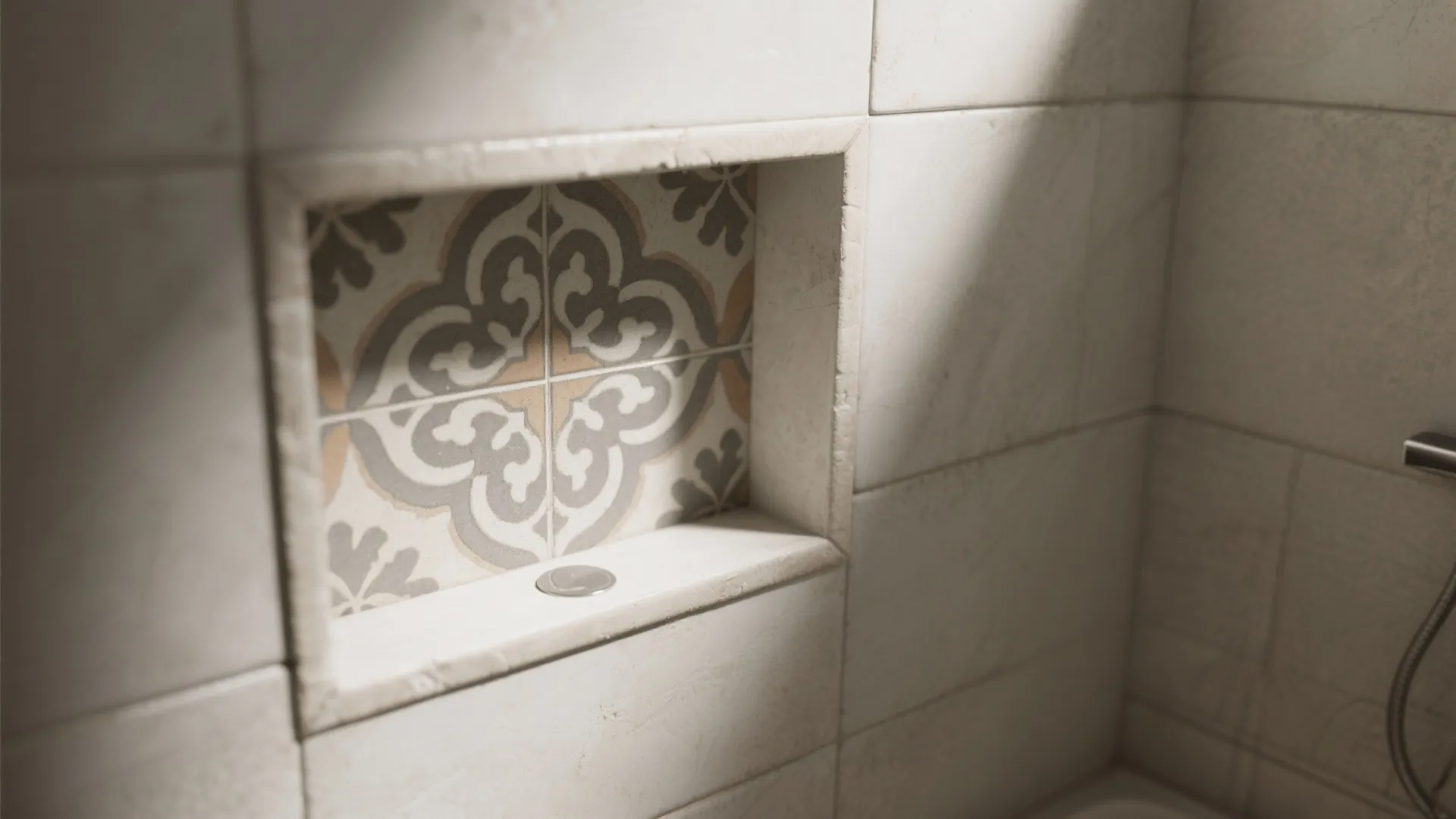 Bathroom wall with square white tiles and a small shelf space featuring decorative pattern tiles