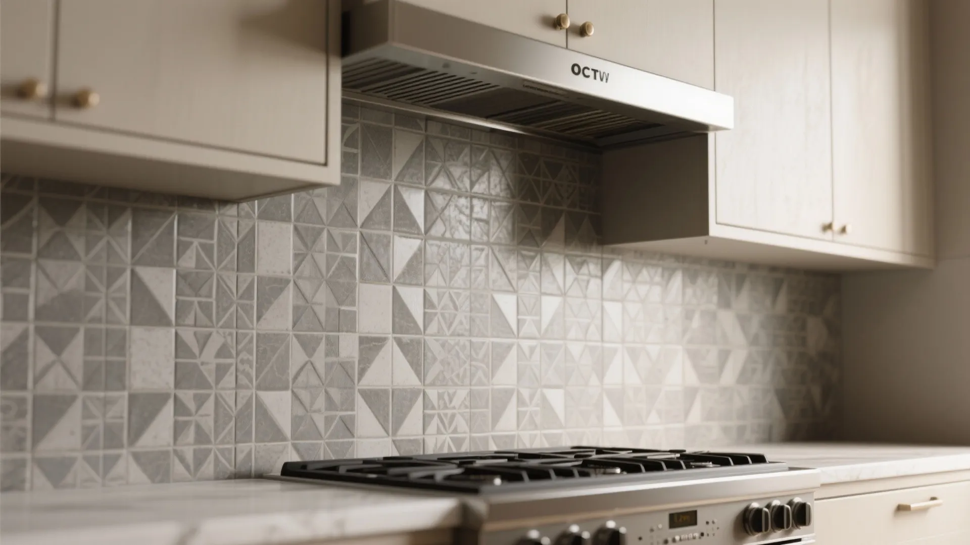 Modern kitchen with geometric pattern wall tiles behind a silver gas stove and beige cabinets