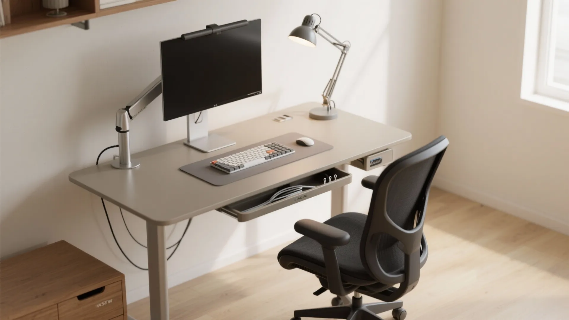 Modern home office setup with ergonomic black chair grey standing desk monitor arm and lamp