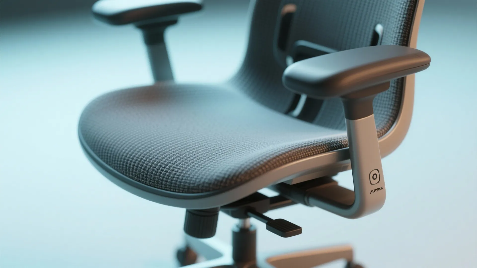 Close up of a grey ergonomic office chair with adjustable armrests and a breathable mesh seat