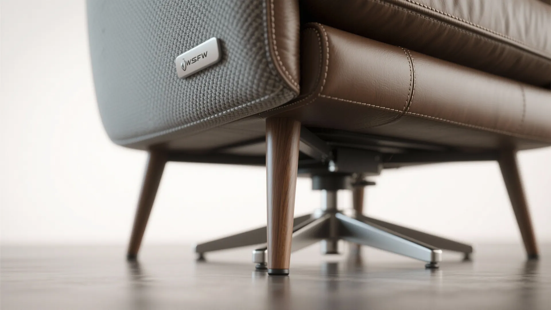 Macro view of exposed wooden leg and performance fabric on a compact swivel recliner.