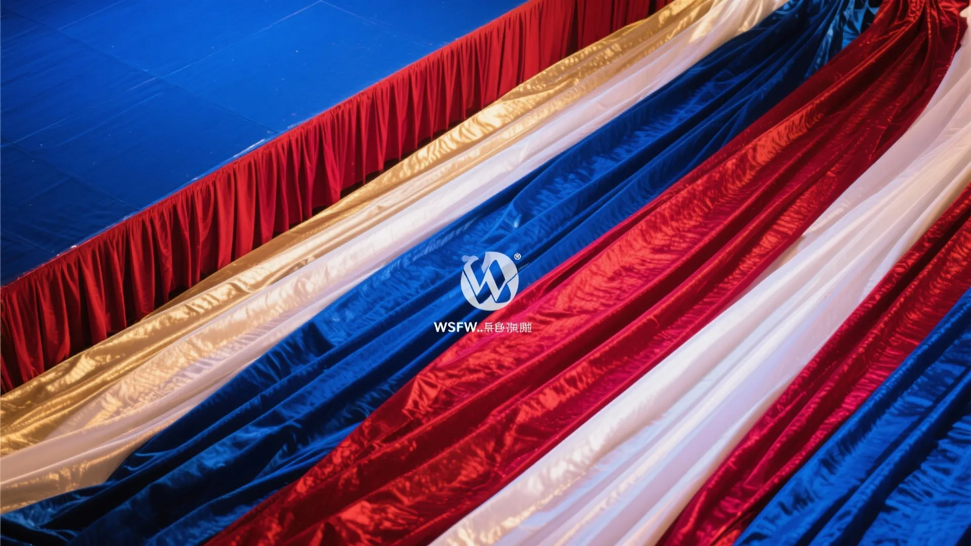 Draped fabric curtain layers in blue red white and gold colors for a stage event
