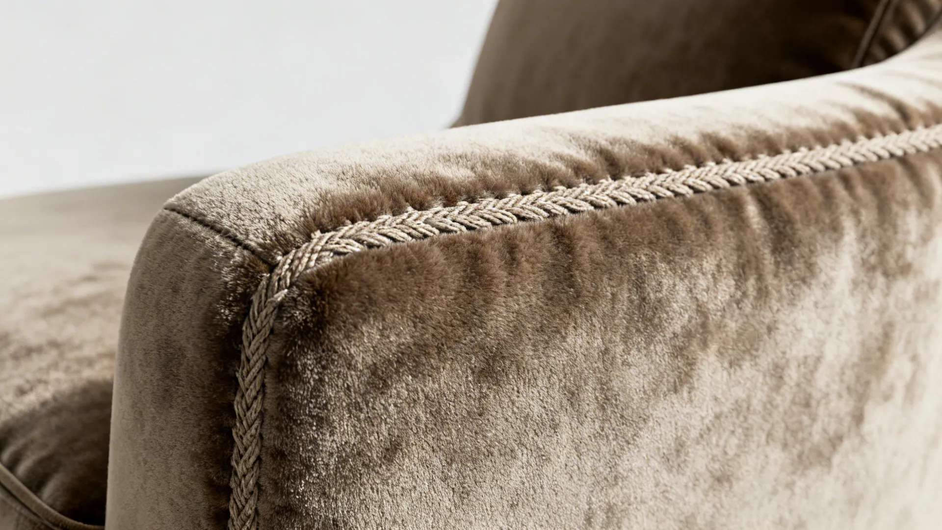 Macro close-up of performance velvet and durable upholstery stitching on a chaise.