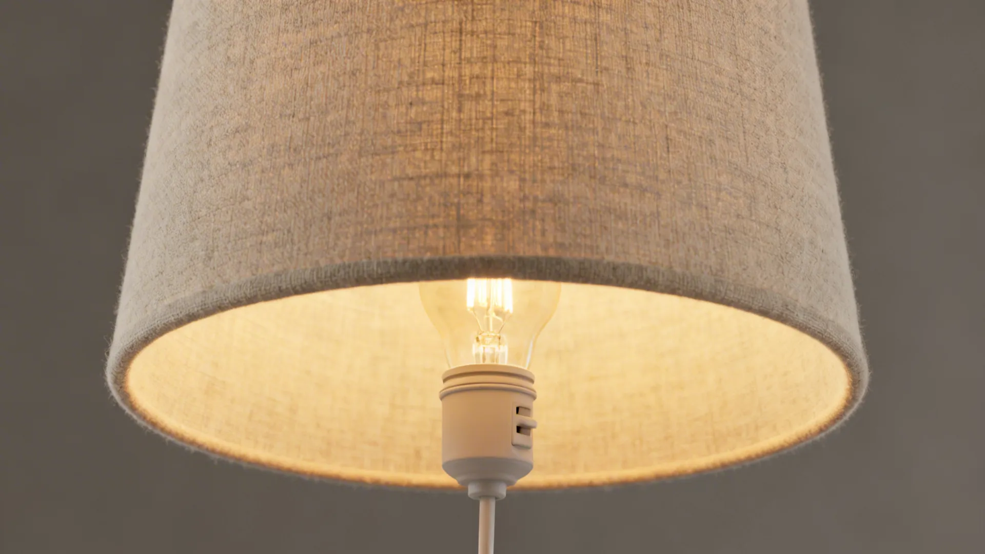Fabric drum shade concealing a plug-in ceiling junction with a warm LED glow.