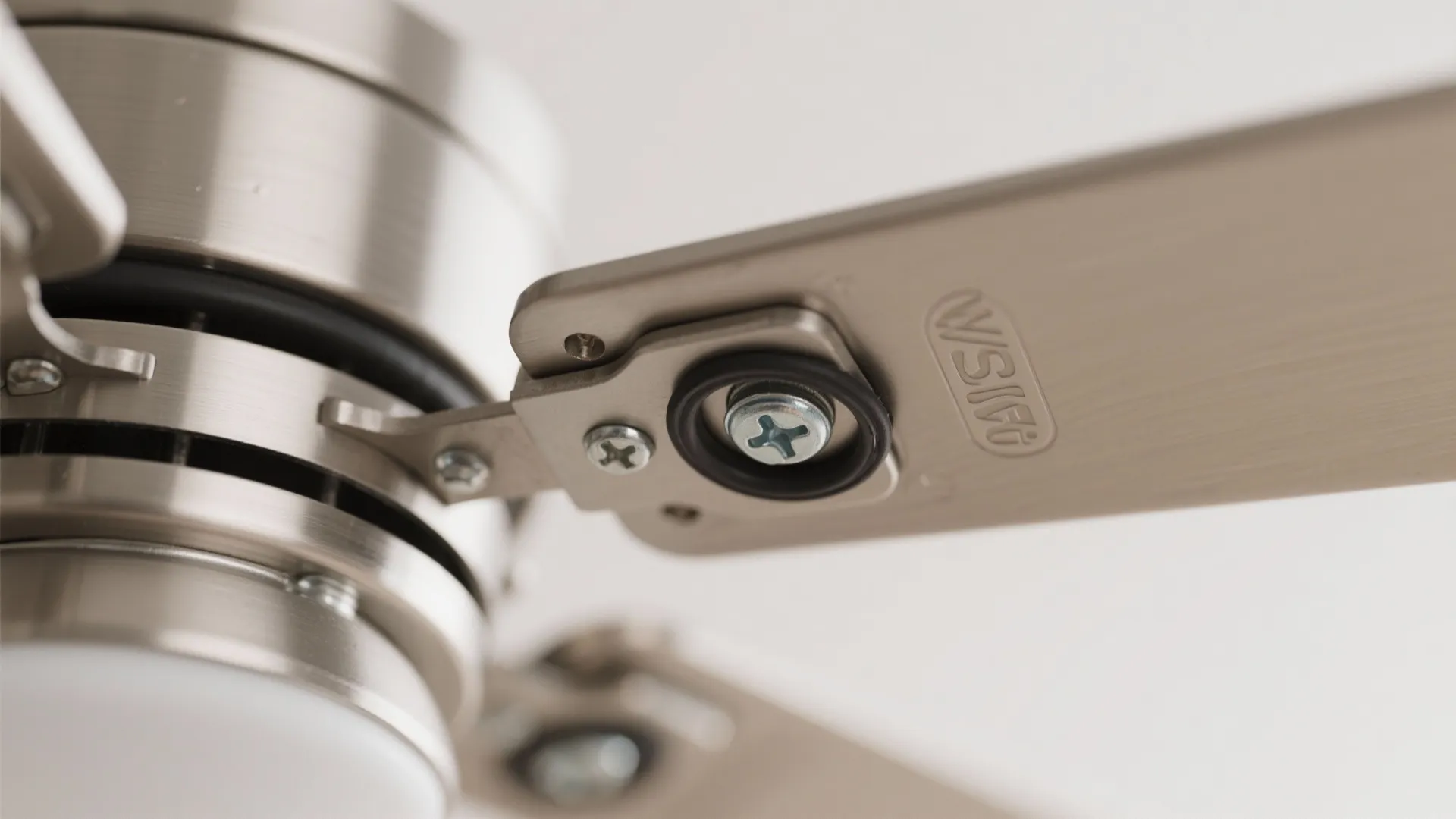 Close-up of a ceiling fan balancing clip and rubber gasket on the mounting hardware.