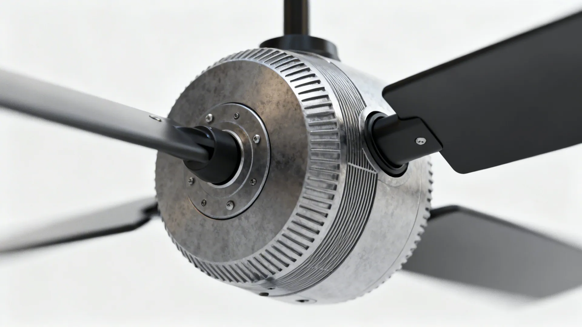 Macro view of a fan motor and blade showing blade pitch and sturdy motor housing.