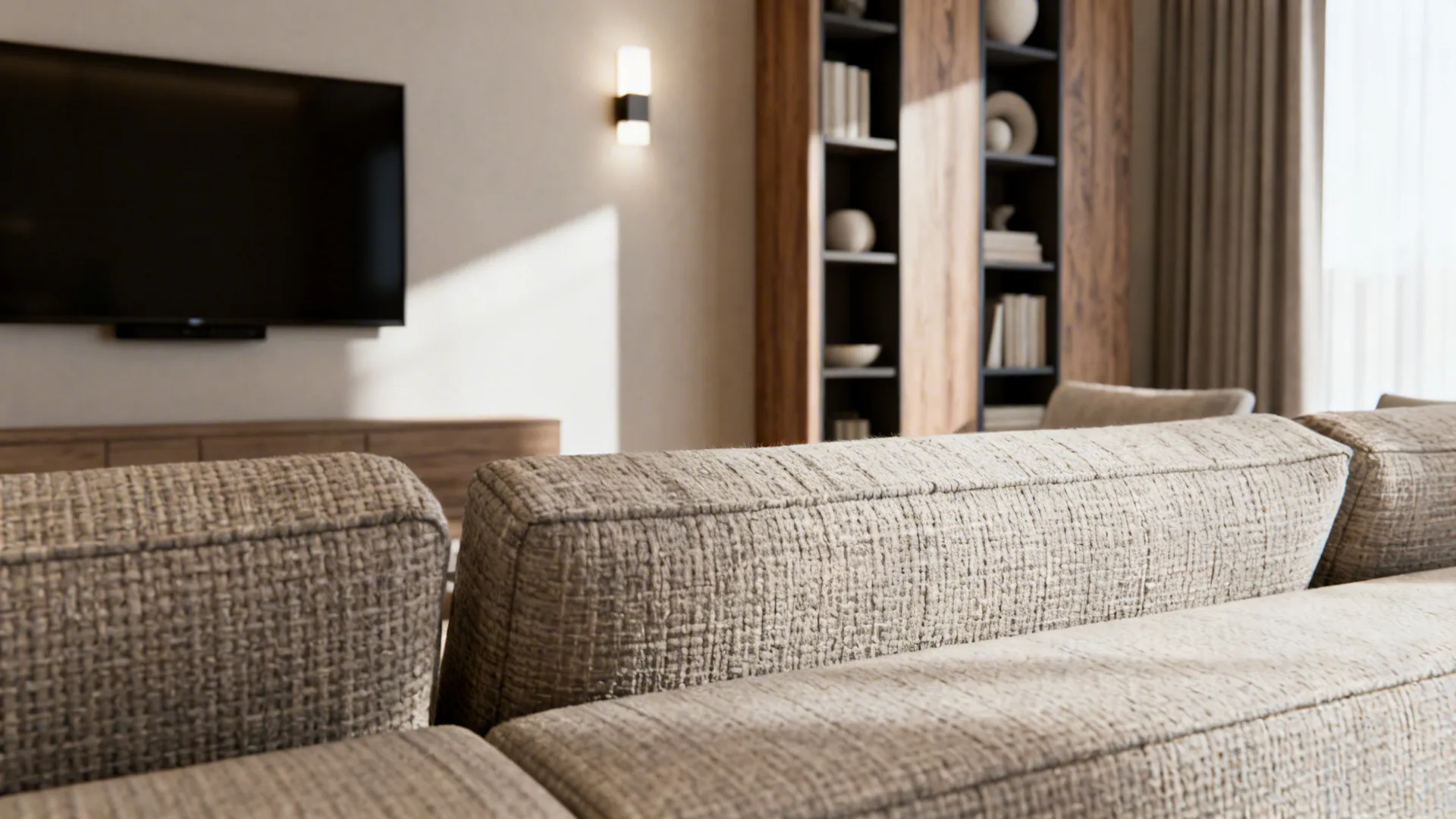 Close-up of low-profile seating, mounted TV on short wall, wall sconce and slim bookshelf showing practical solutions.