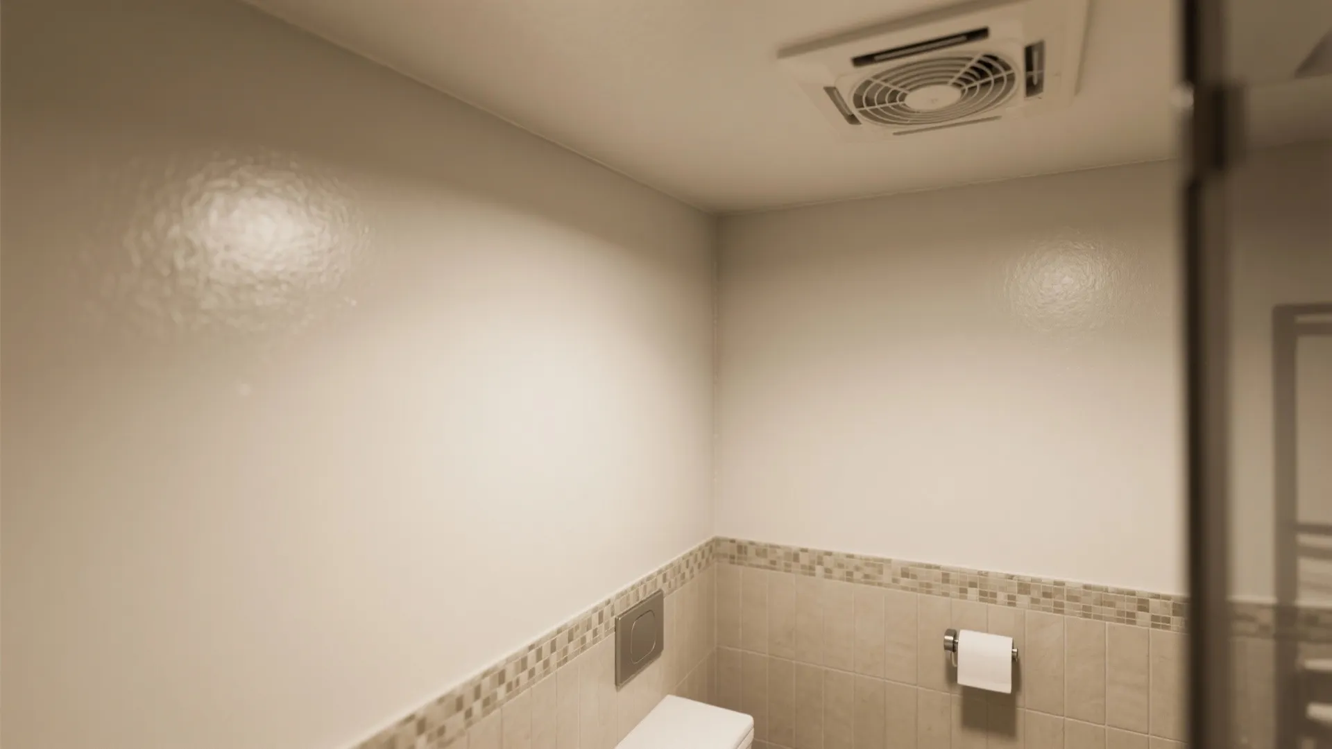 Close-up of semi-gloss painted wall next to an exhaust fan and sealed tile transition illustrating finishes and ventilation.