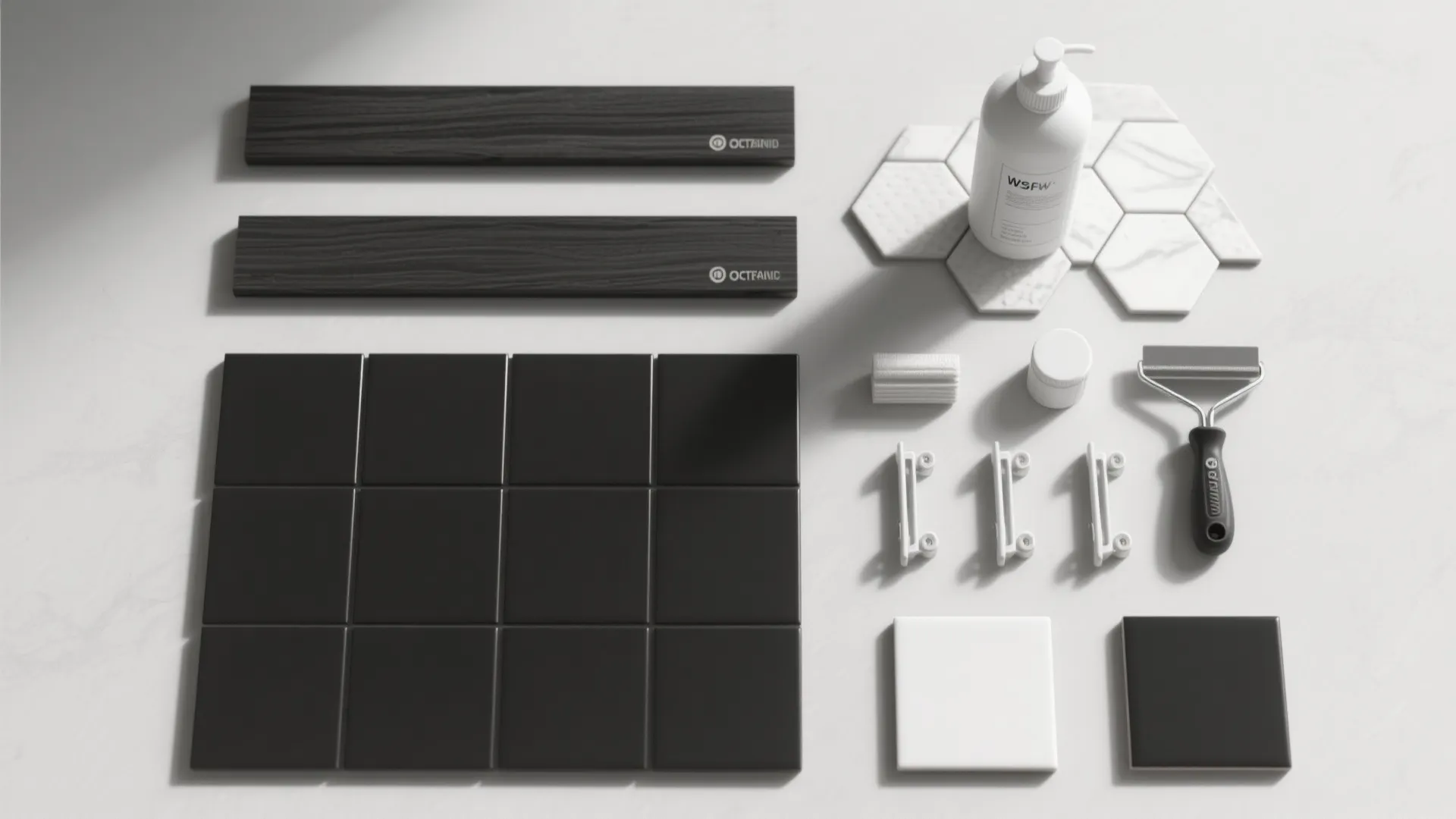 Top-down flatlay of black and white tile samples with spacers and tools.