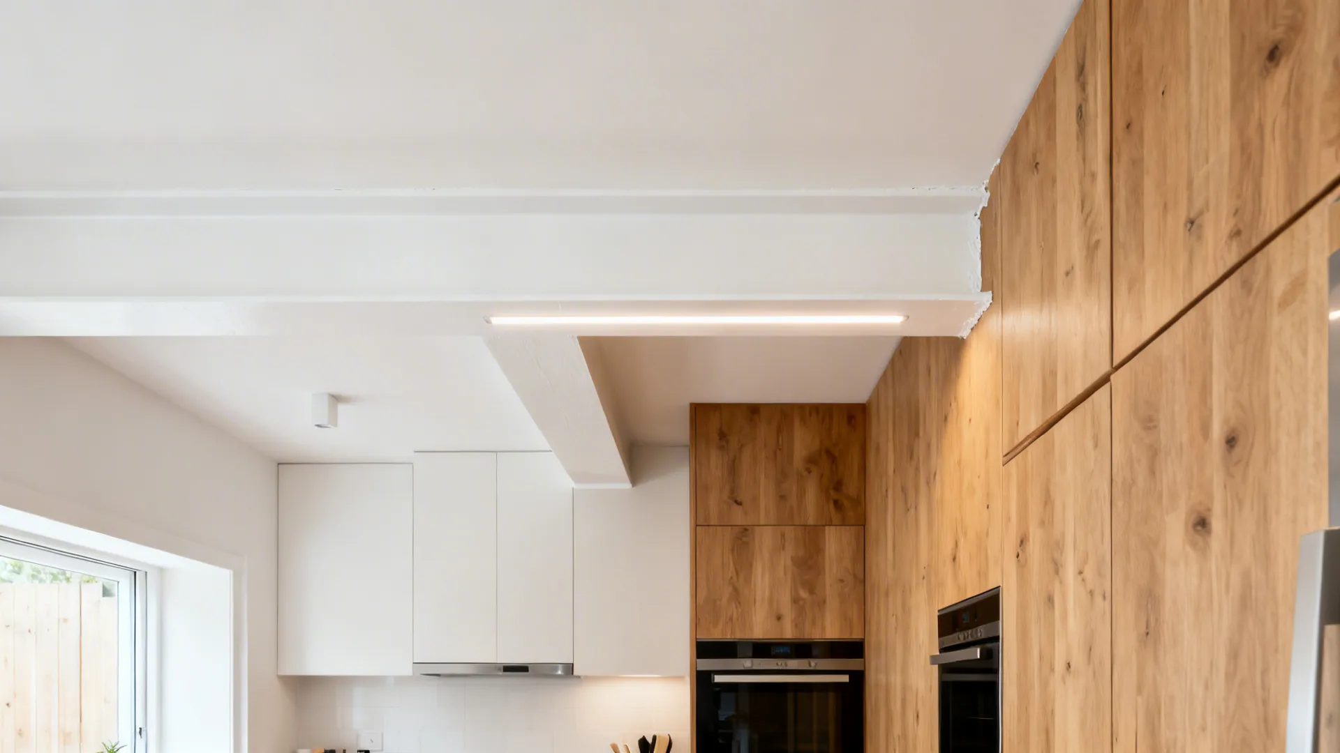 Compact kitchen demonstrating slim beams, painted beams, and a small faux beam with LEDs.