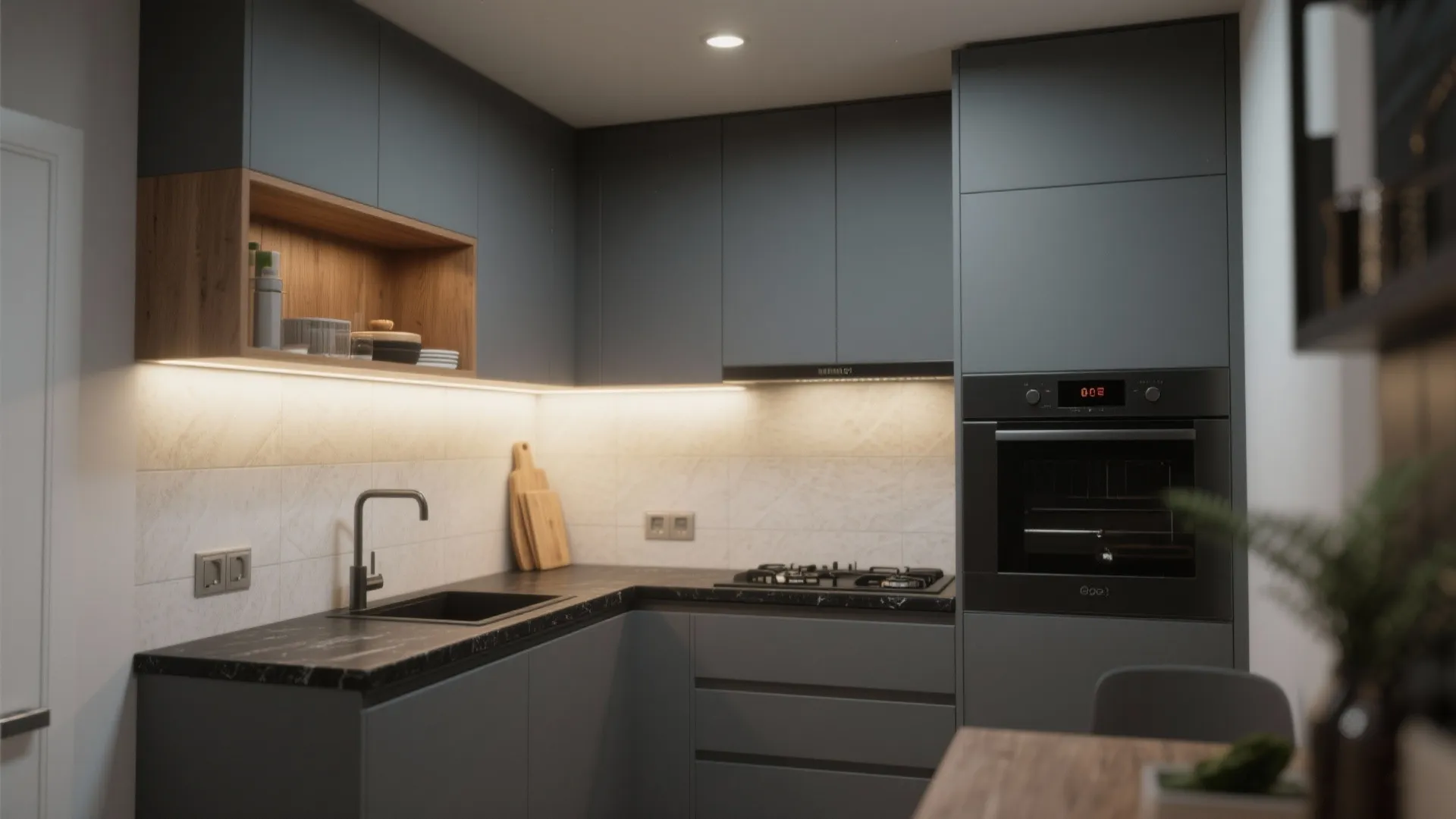 Compact intentional kitchen with gray cabinets, black countertop, warm accents and layered lighting.