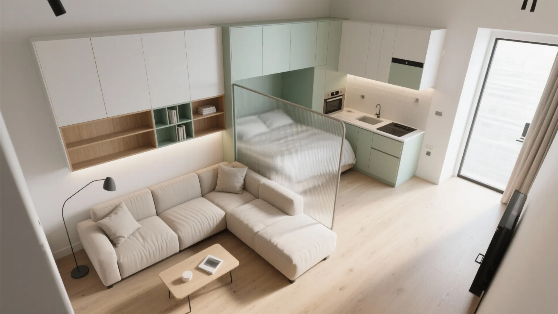 Modern studio apartment with beige sofa and small kitchen separated from bed by glass screen