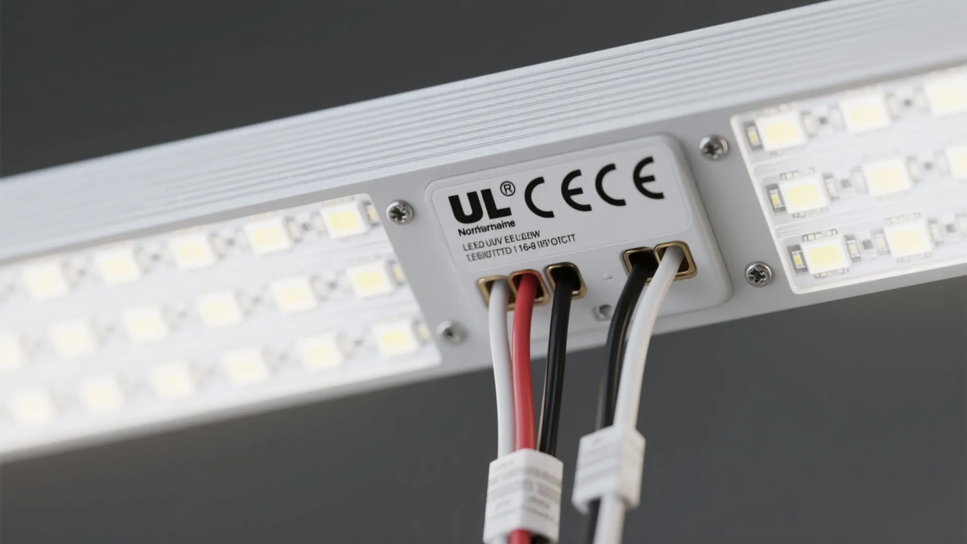 Close-up of LED picture light components and certification label indicating safe fixture standards.