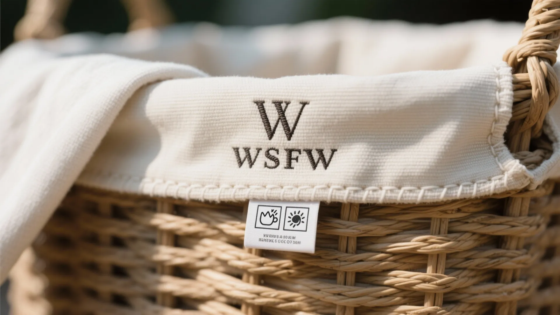 Close up of a woven basket with white fabric liner showing care instructions on tag