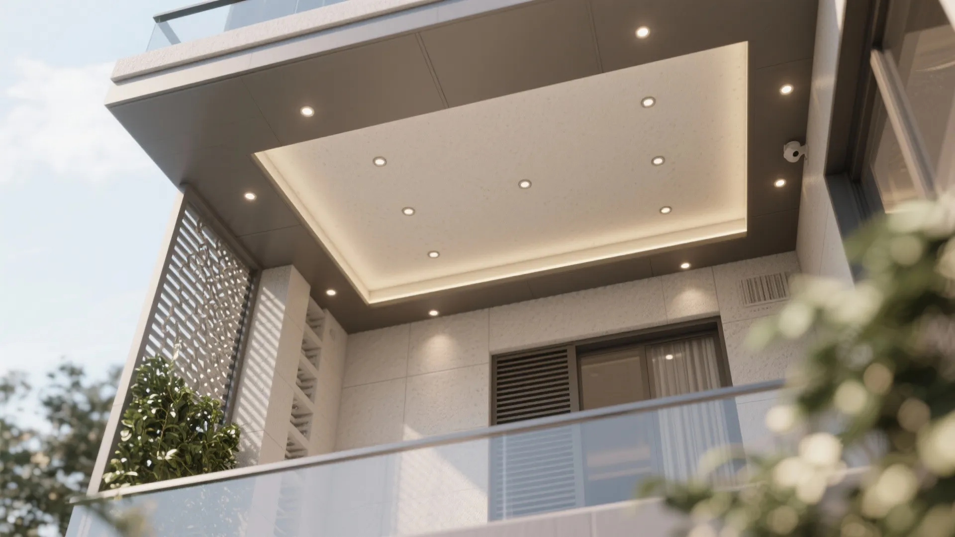 Exterior balcony view looking up at modern ceiling light fixtures with glass railing and green plant