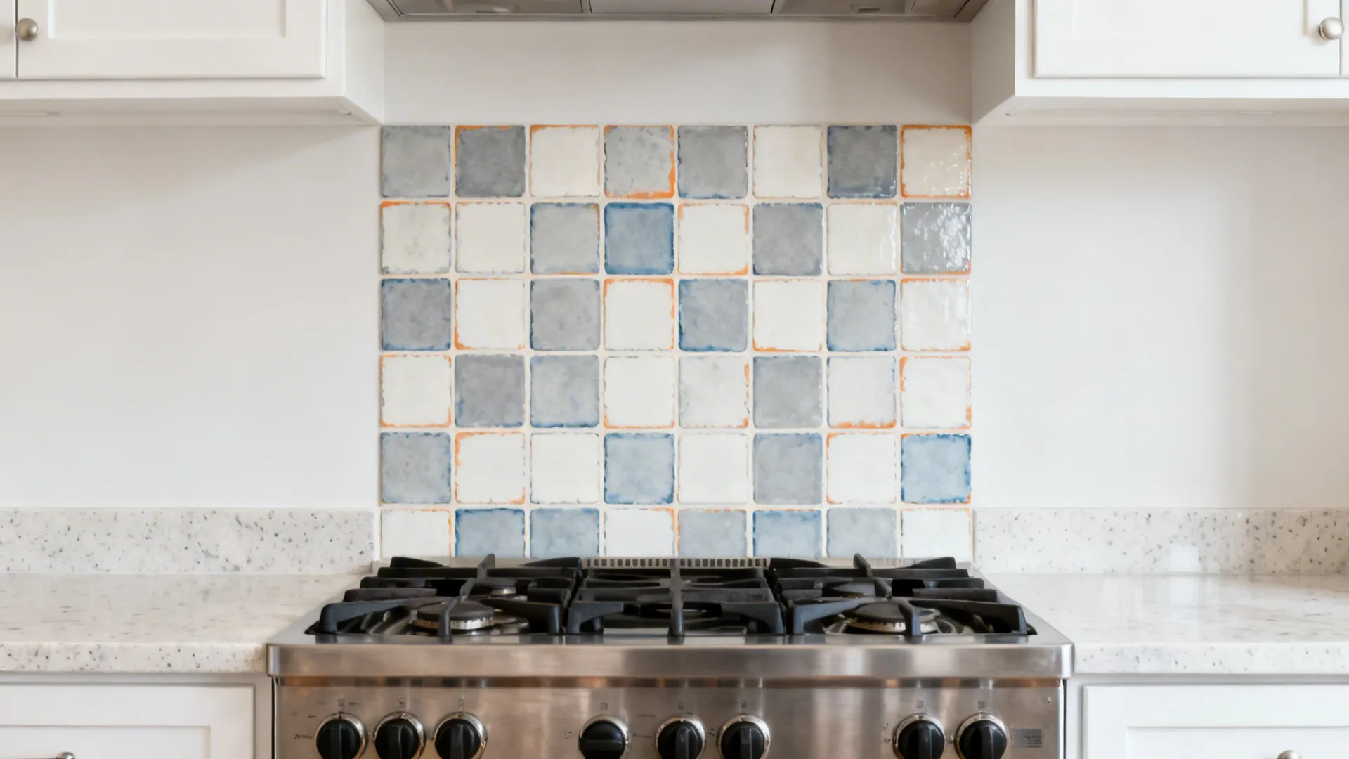 Stove wall with Zellige-inspired faux tile stencil panel in soft gray-blue and white.