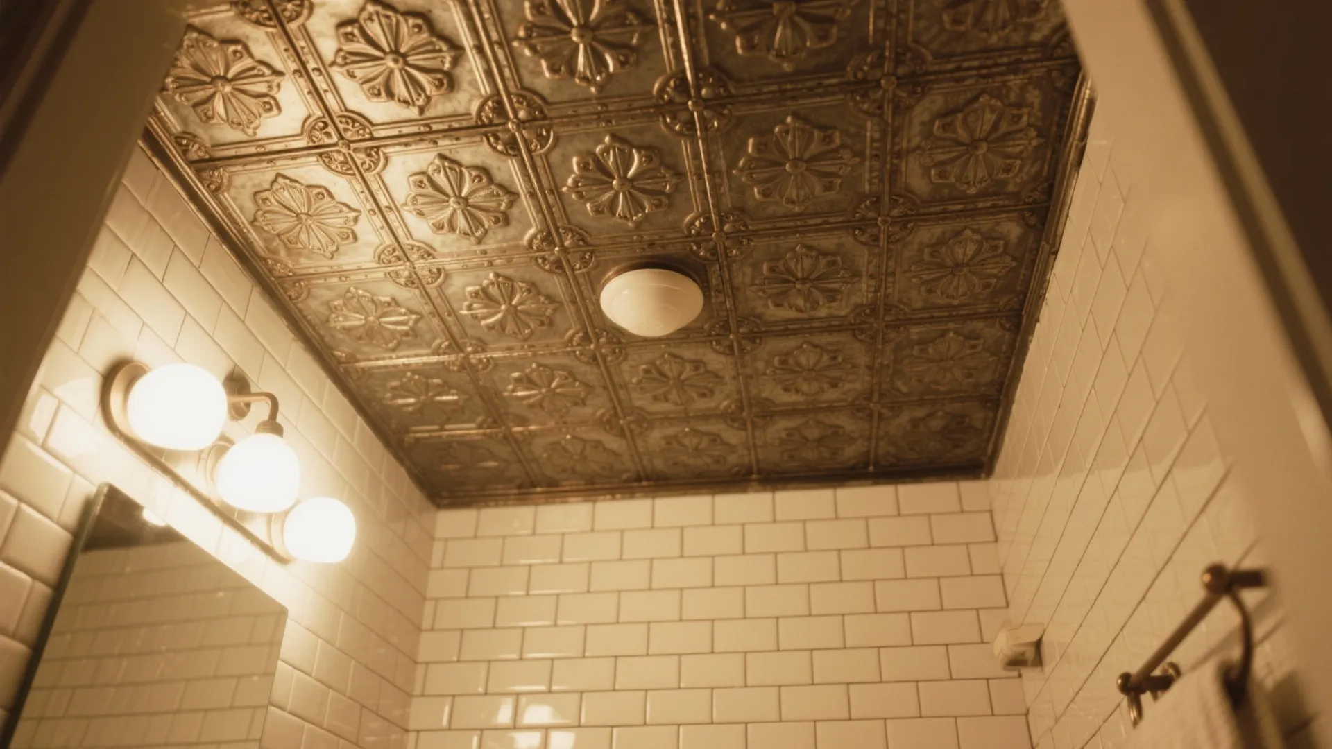 Classic bathroom interior with vintage style patterned ceiling tiles white wall tiles and wall light