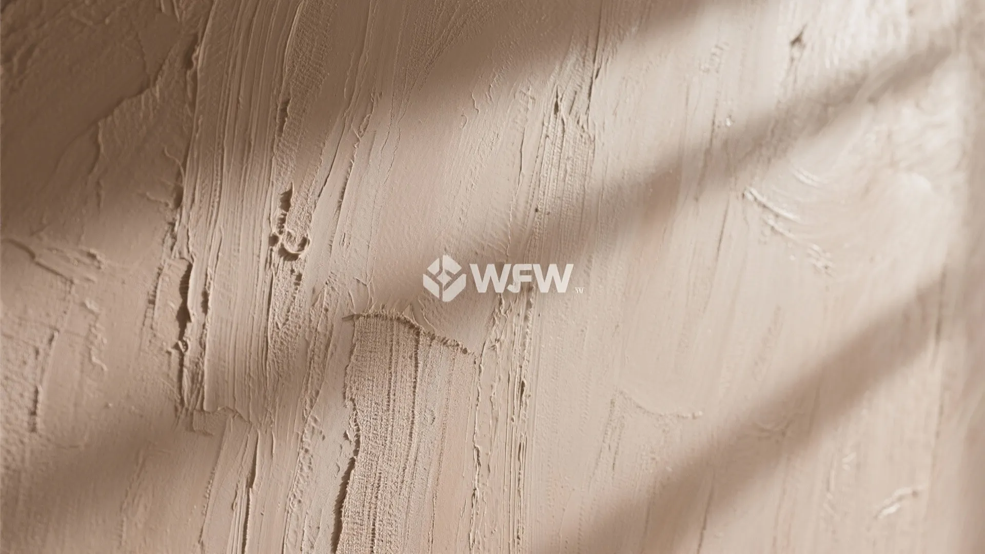 Close-up of a wall with a subtle glaze wash faux finish showing texture and layered tones.