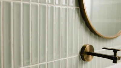 Soft Mint Bathroom Tile Design with Brass Fixtures