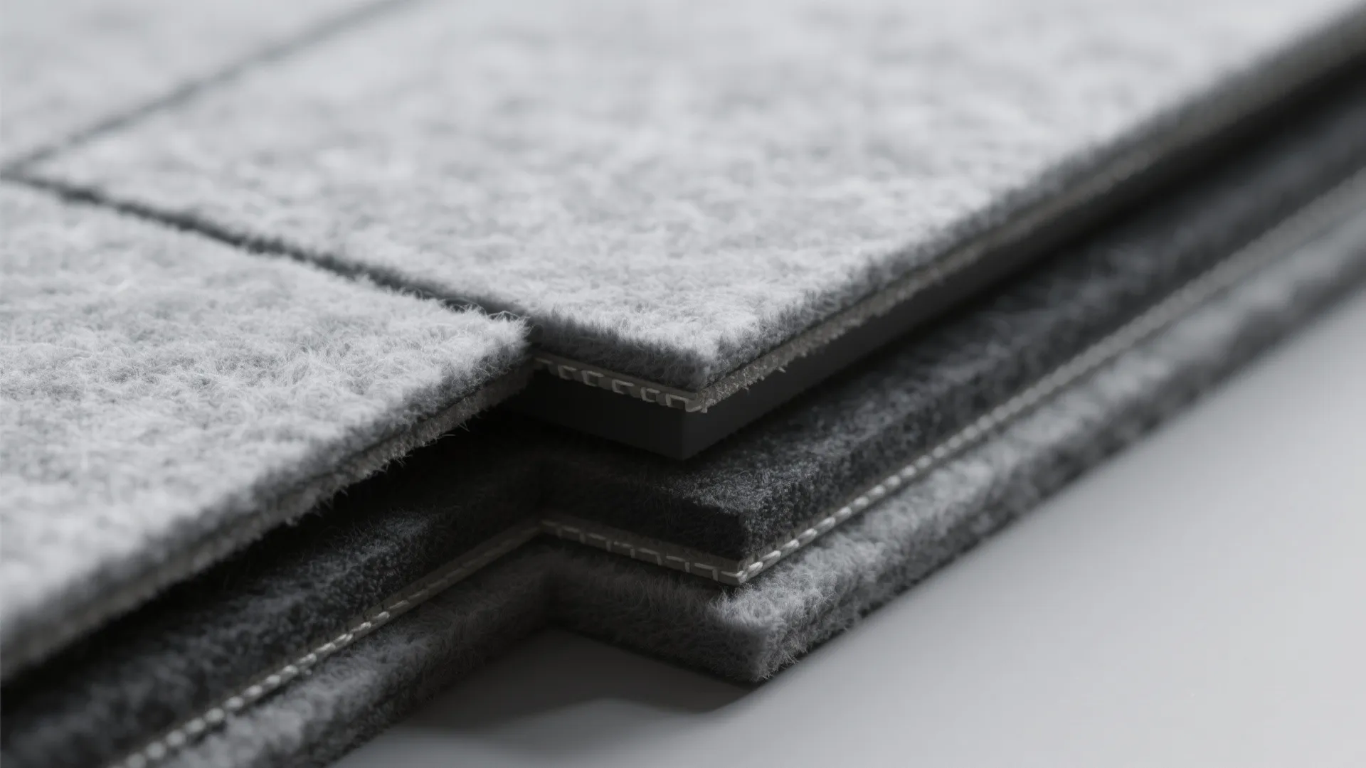 Macro detail of PET felt tile with beveled edge and soft fiber texture.