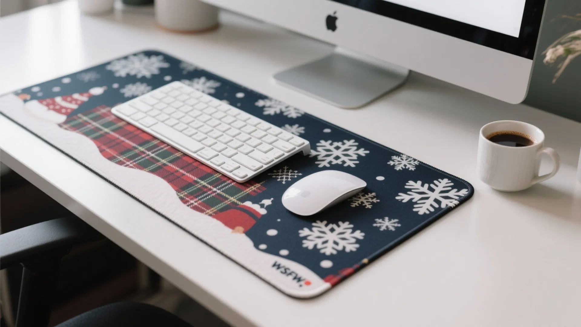 Festive desk mat with snowflake patterns holding a white keyboard mouse and coffee on desk
