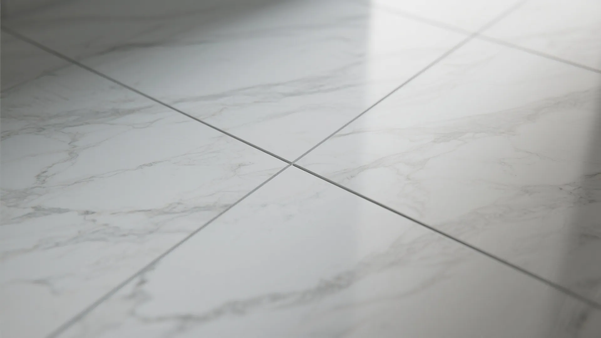 White marble floor tiles with grey veins and narrow grout lines in a bright room