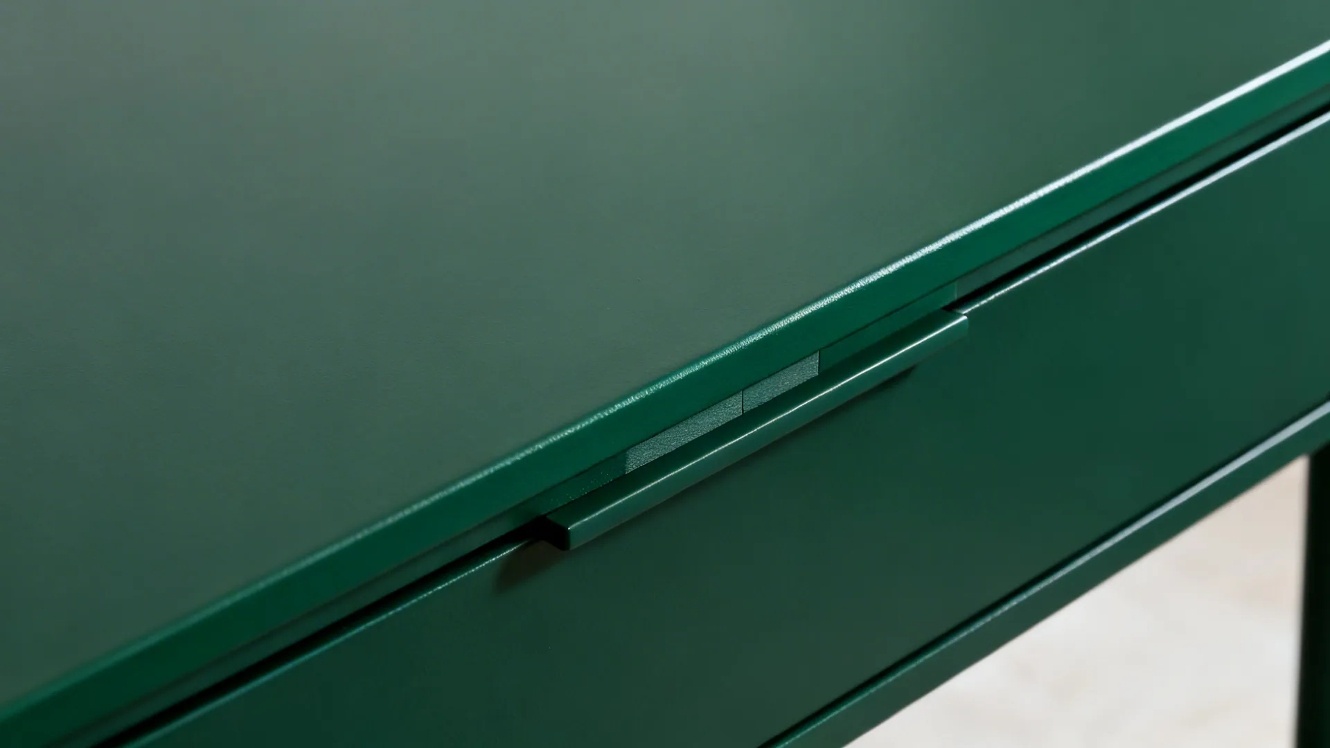 Macro of matte green tabletop with tone-on-tone boundary line and removable center stripe