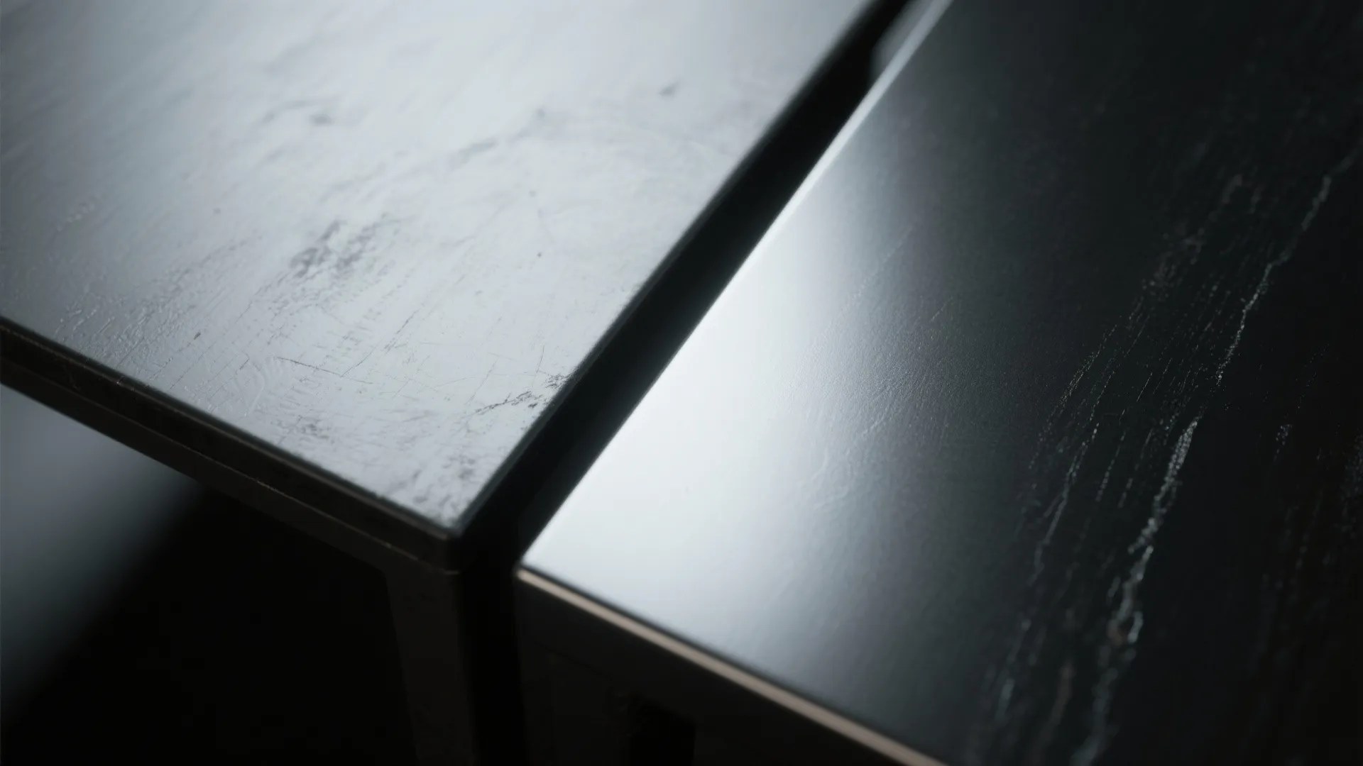 Macro comparison of matte black and satin black tabletop finishes showing texture and subtle reflections.