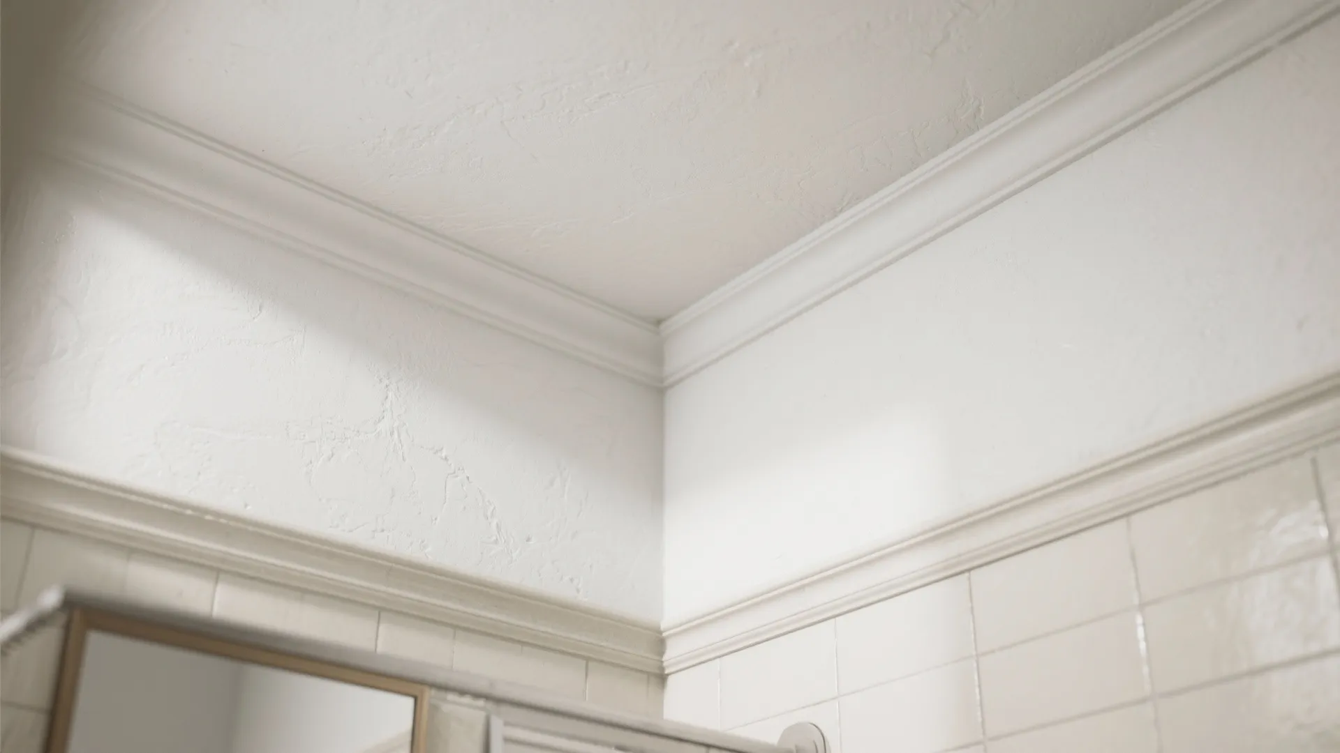 Close-up of a moisture-resistant flat white bathroom ceiling corner showing subtle texture