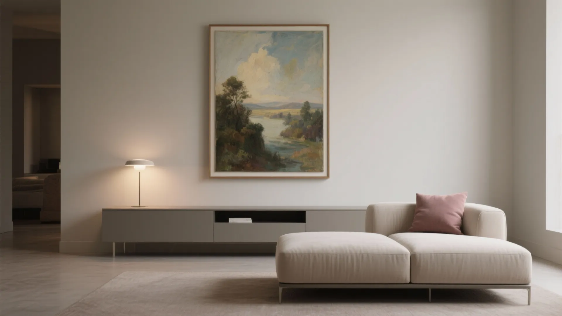 A large painting floated above a low-profile sofa and slim console with generous margins and soft lighting.
