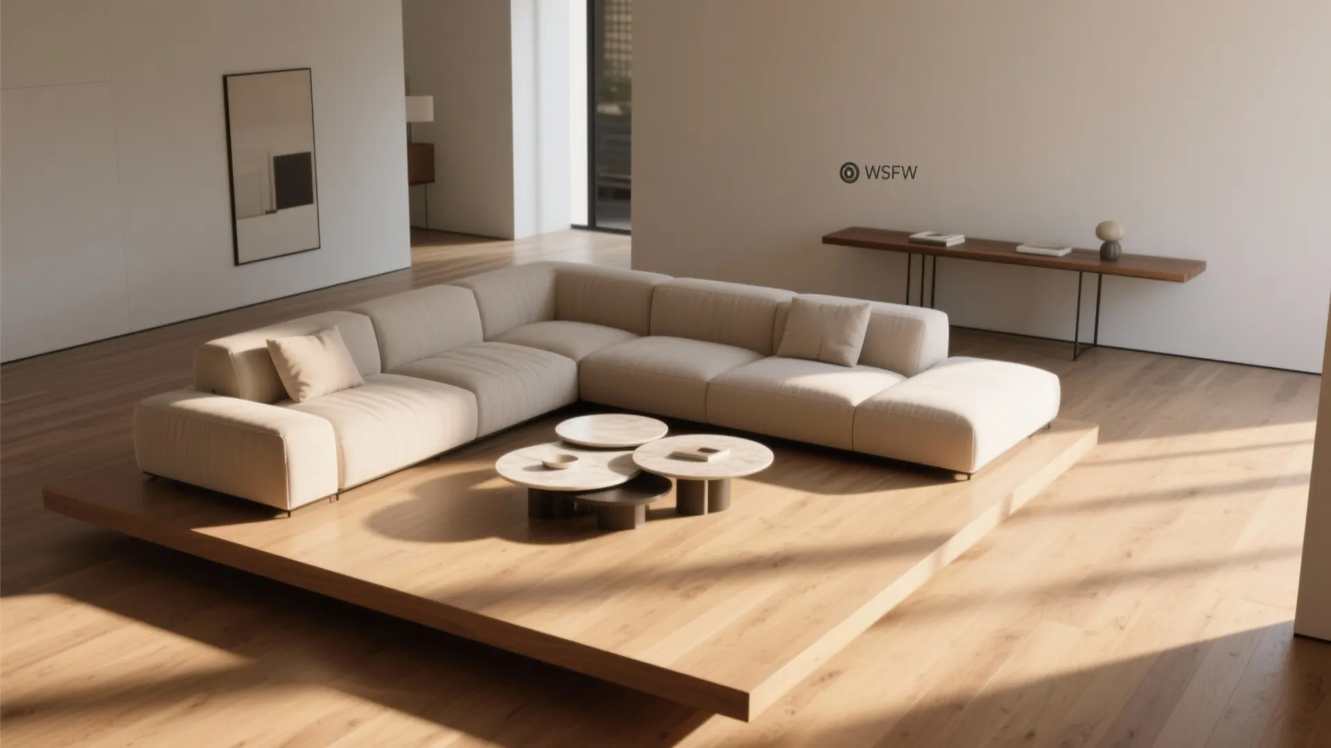 Large beige sofa on raised wooden floor platform with round coffee tables and natural light