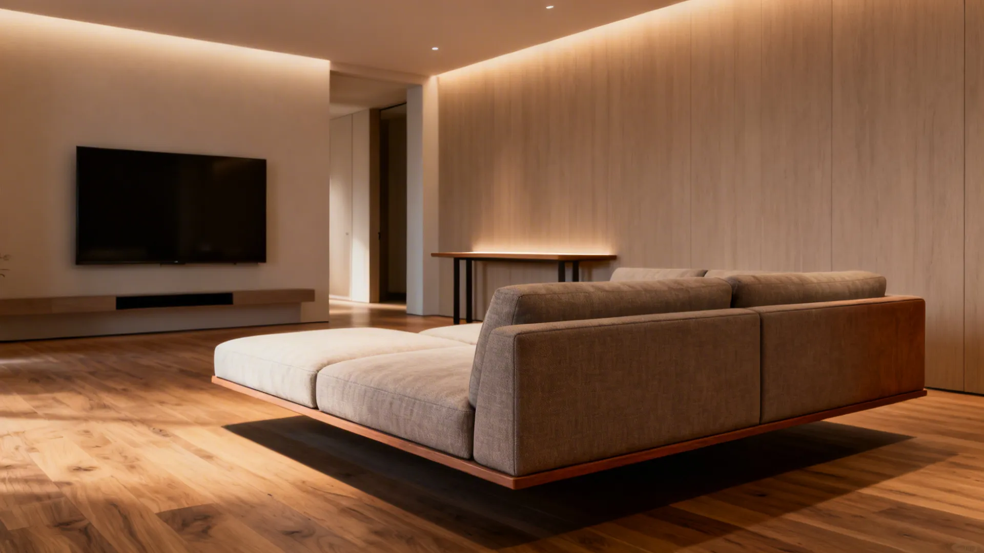 Low-profile sectional floated perpendicular to long wall with slim console behind, open sightlines.