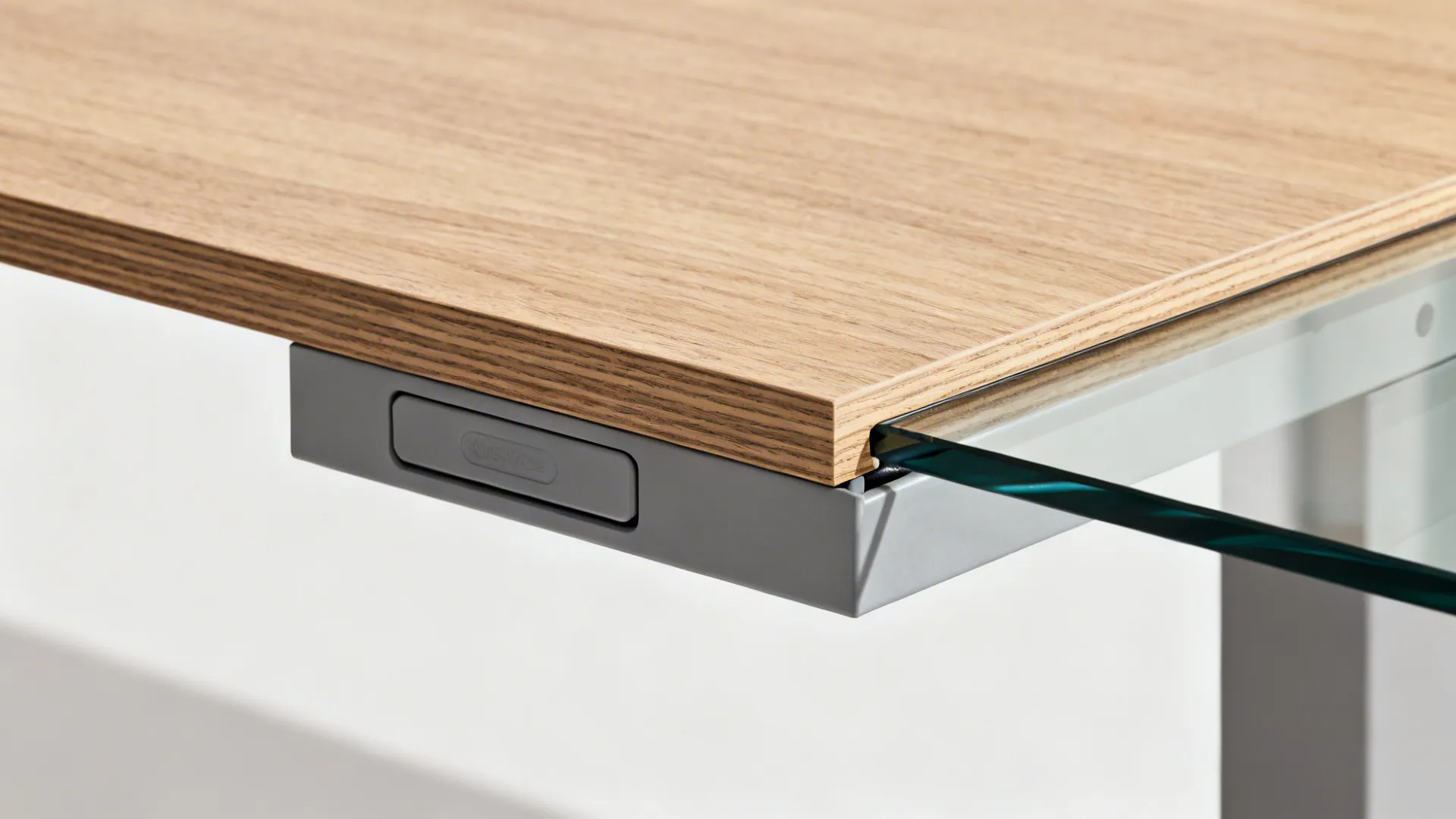 Close-up of floating desk edge, steel bracket, and concealed cable raceway.