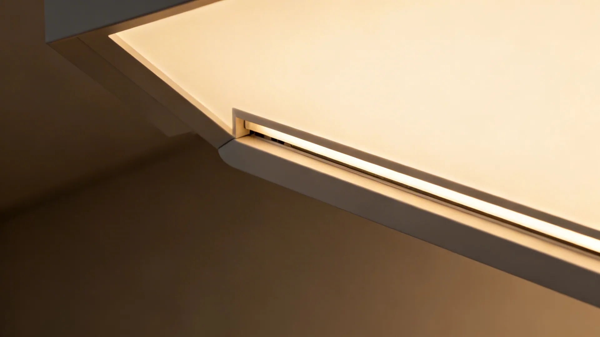 Macro of a floating ceiling panel reveal with opal diffuser and hidden LED strip creating even glow.