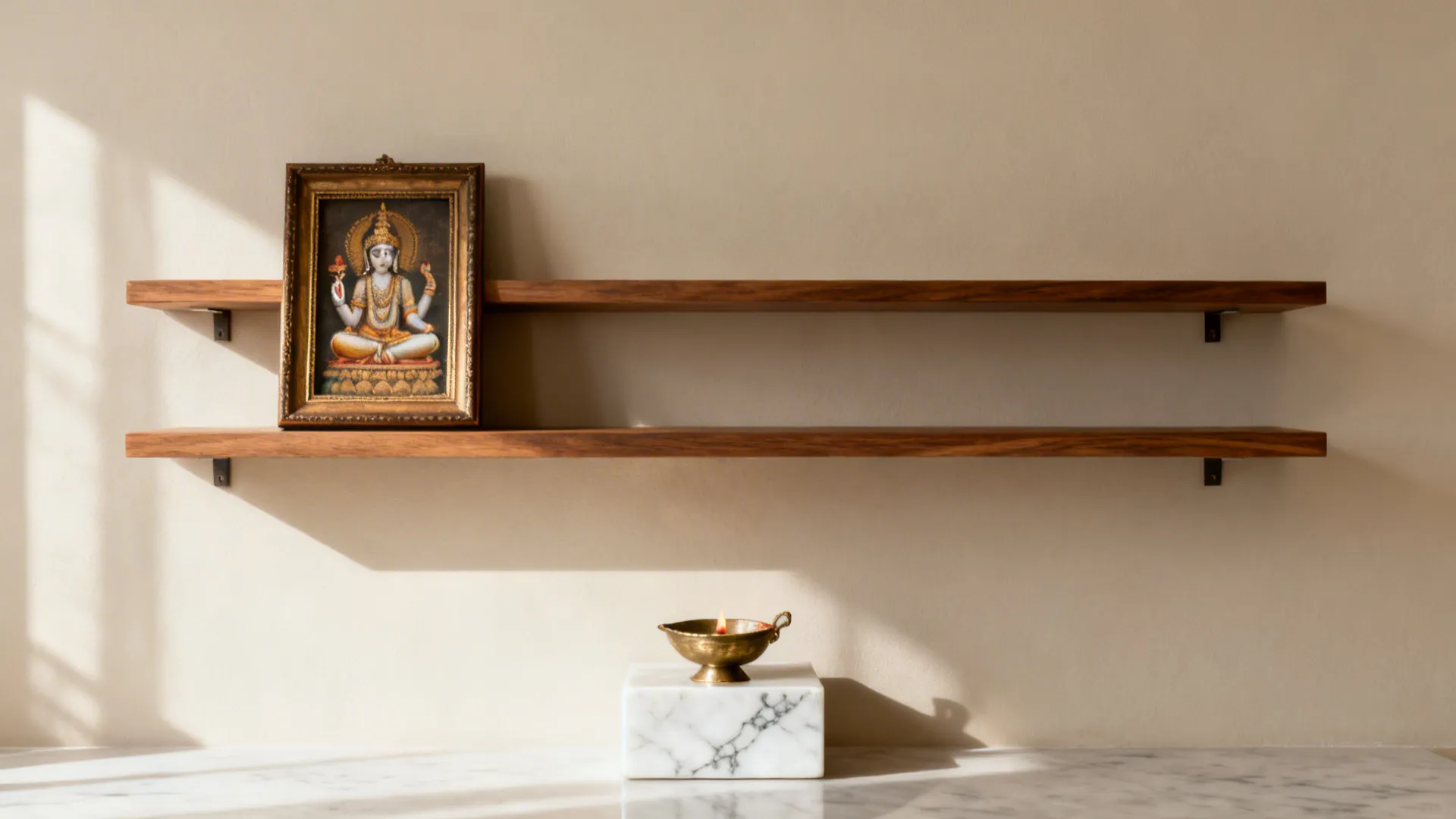Minimal floating oak shelves above a white marble inlay with a brass diya.