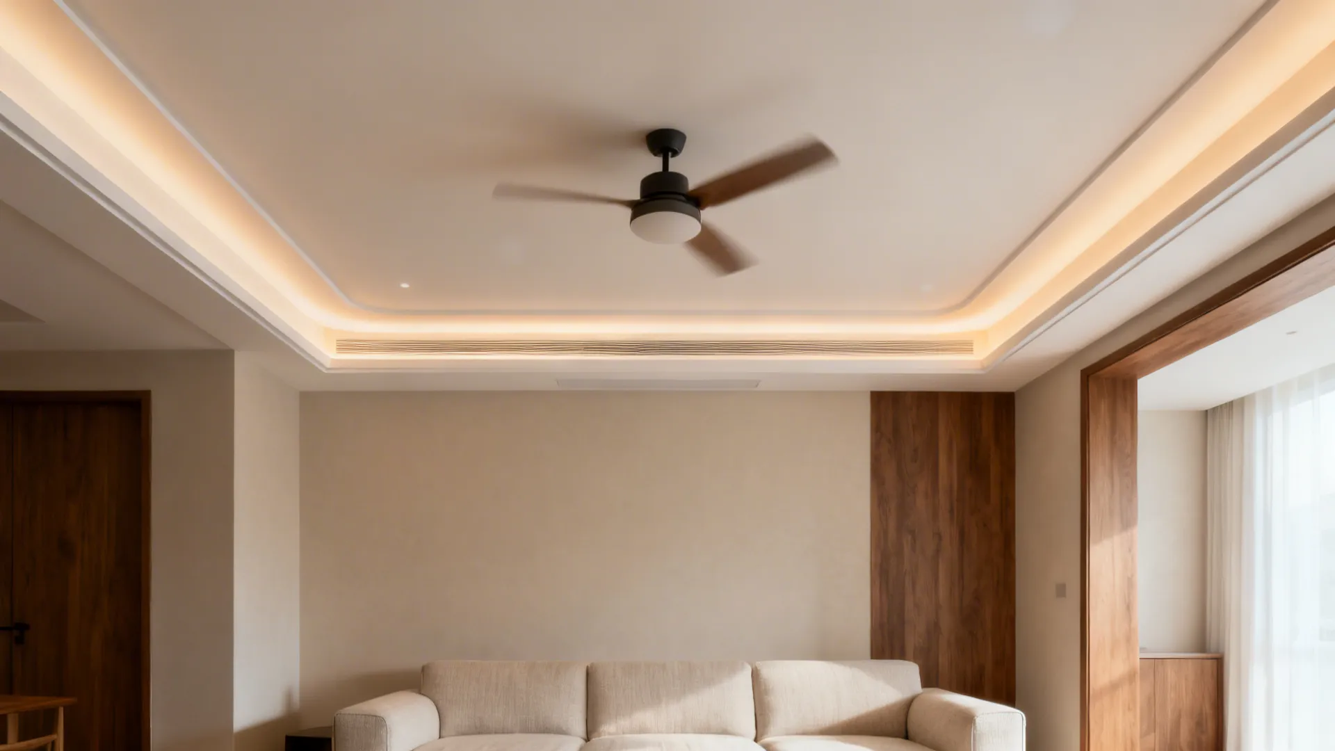 Floating tray ceiling with soft uplight and a compact fan centered over seating.
