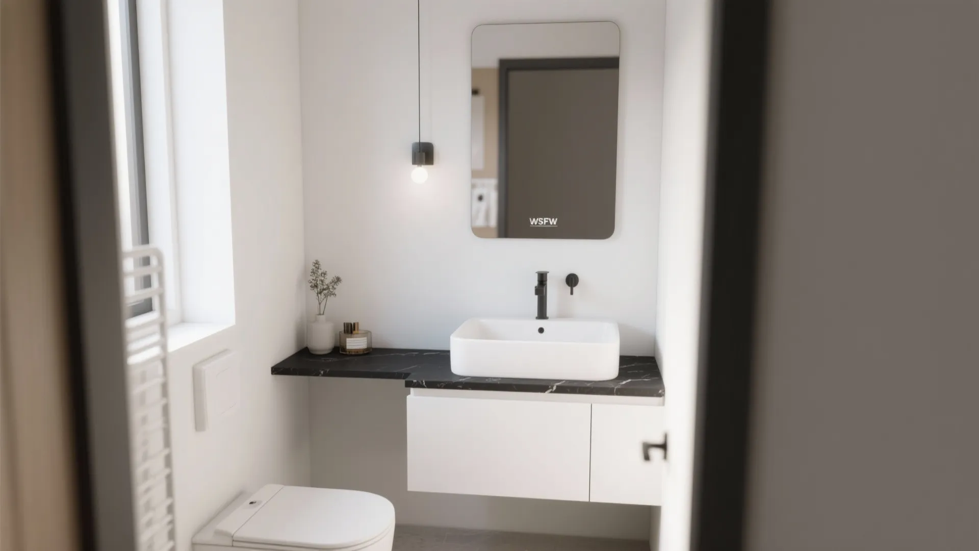Small minimalist bathroom with white sink black marble counter wall light mirror and a white toilet