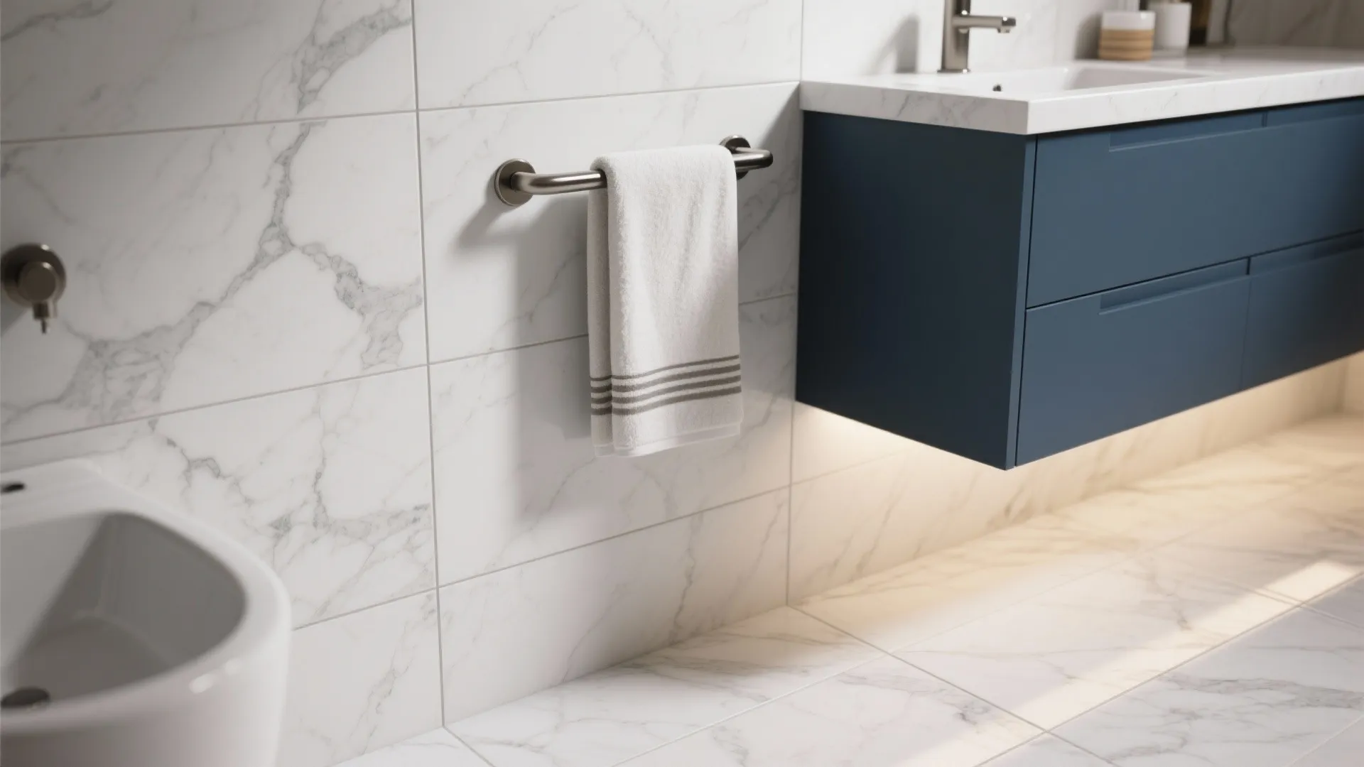 White marble wall and floor tiles with blue floating cabinet and a white hand towel rail