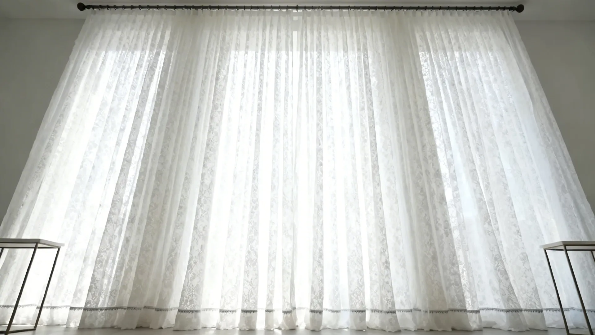 Room with ceiling-mounted rod and floor-to-ceiling white lace curtains creating added height.
