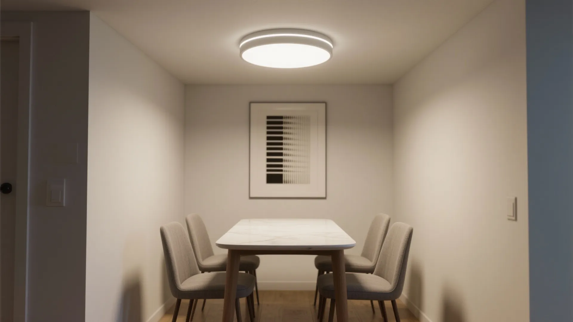 Modern dining area featuring a white marble table grey chairs and a round ceiling light