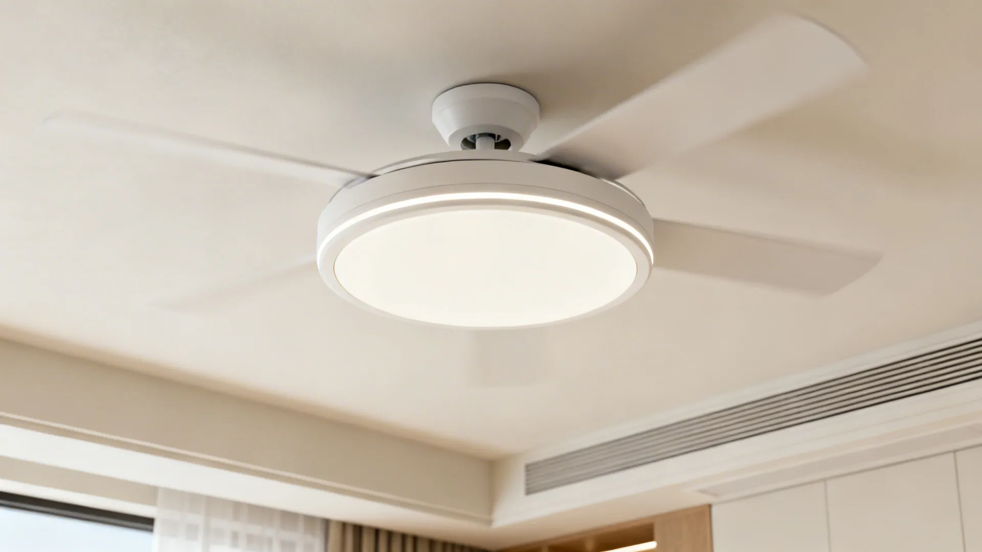 Close-up of a low-profile flush mount ceiling fan installed on a low ceiling in a modern apartment.