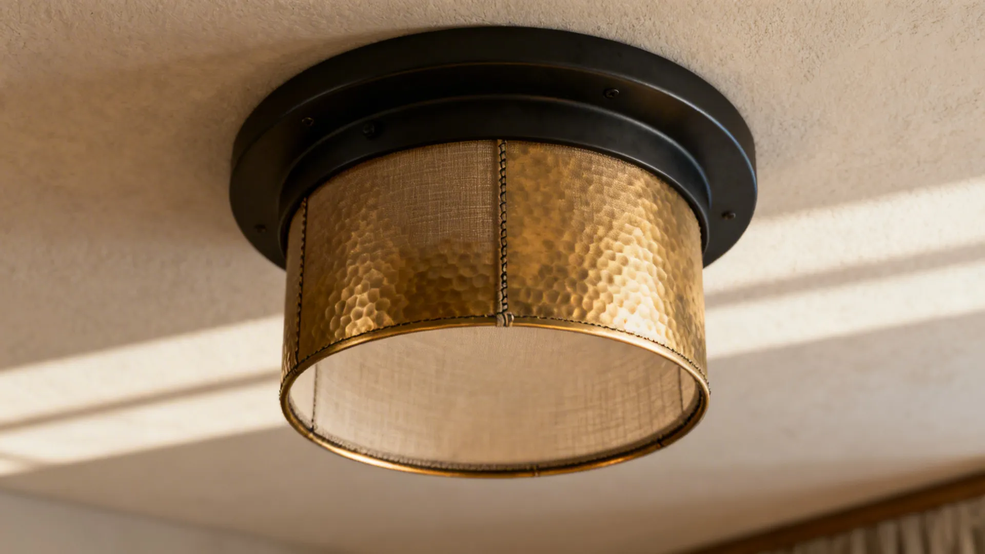 Textured drum-style flush mount light on a low ceiling showing material detail