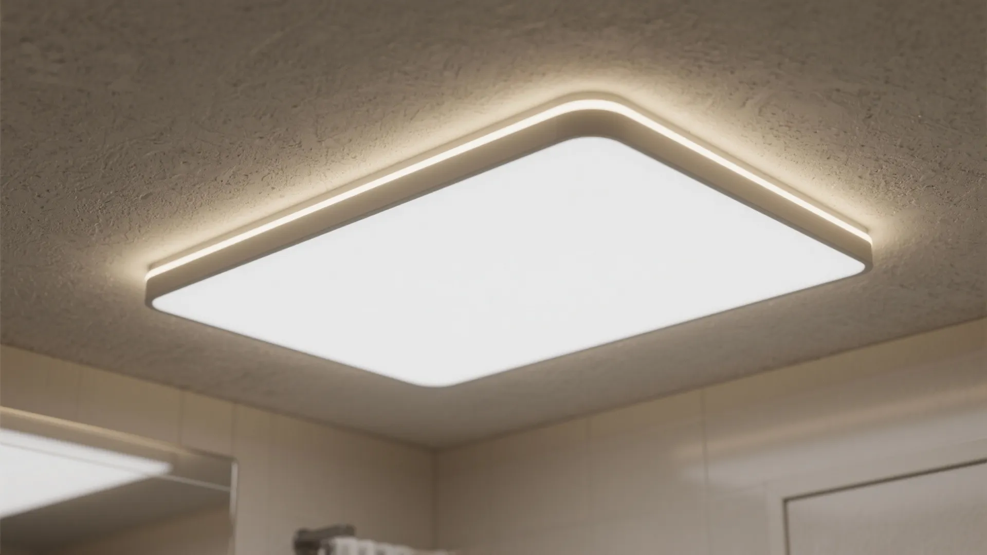 Minimalist rectangular white ceiling light fixture with warm glow installed on a textured beige ceiling