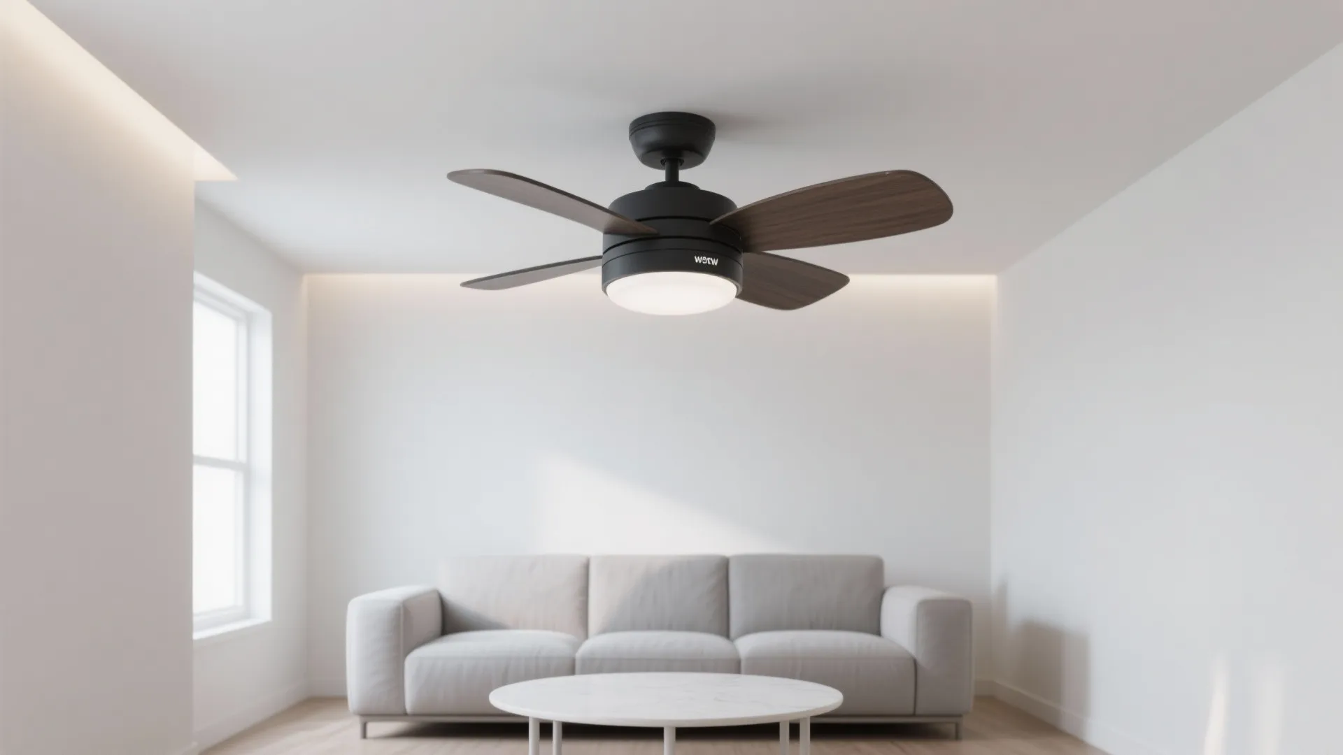 Black ceiling fan with light and wooden blades in white living room with grey sofa