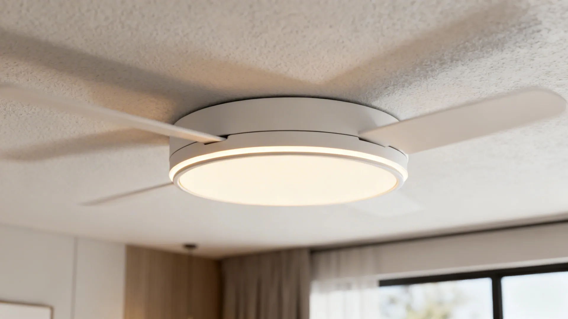 Close-up of a flush-mount LED ceiling fan in a low-ceiling modern bedroom